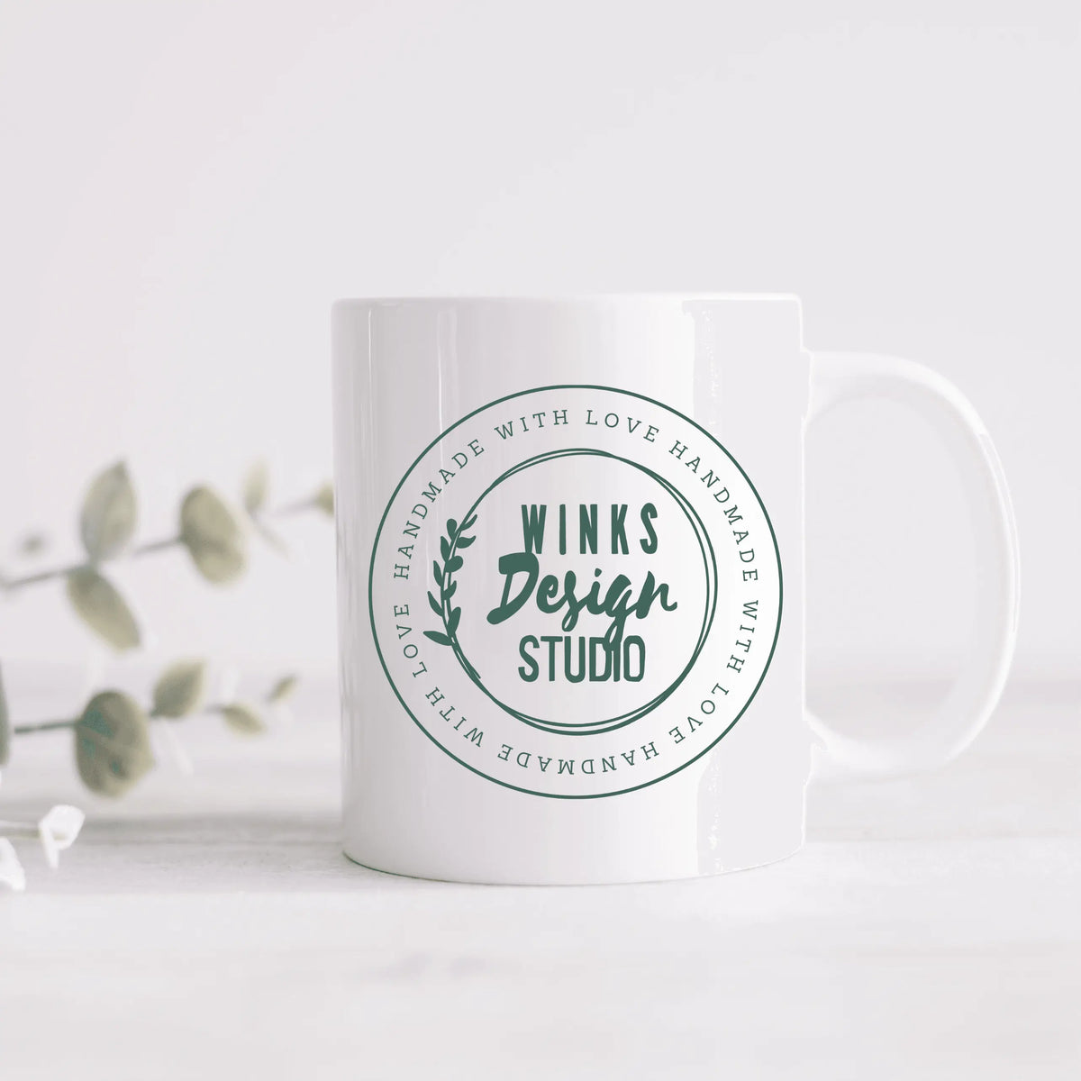 Winks Design Studio LLC WDS ceramic mug with a smooth white surface and comfortable handle, ideal for hot beverages.
