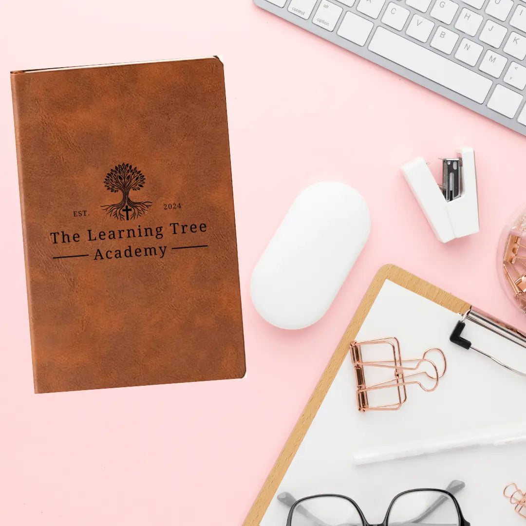 Leather journal from Winks Design Studio, The Learning Tree Academy, featuring a textured cover and lined pages for writing notes.