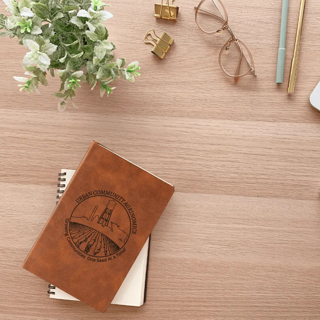 Winks Design Studio LLC UCAN leather journal with textured brown cover and blank pages, ideal for writing and note-taking.