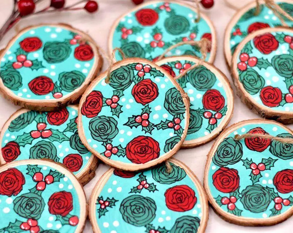 Hand-painted wooden Christmas tree ornament by Winks Design Studio featuring red roses, perfect for festive holiday decor.