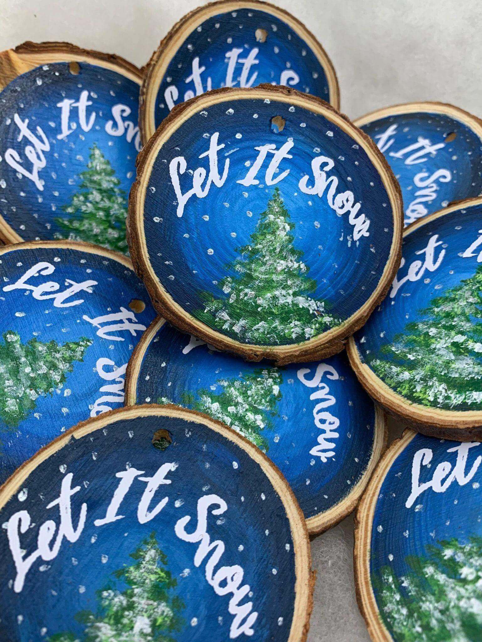 Hand-painted wood slice Christmas ornament featuring "Let it Snow" design by Winks Design Studio LLC.