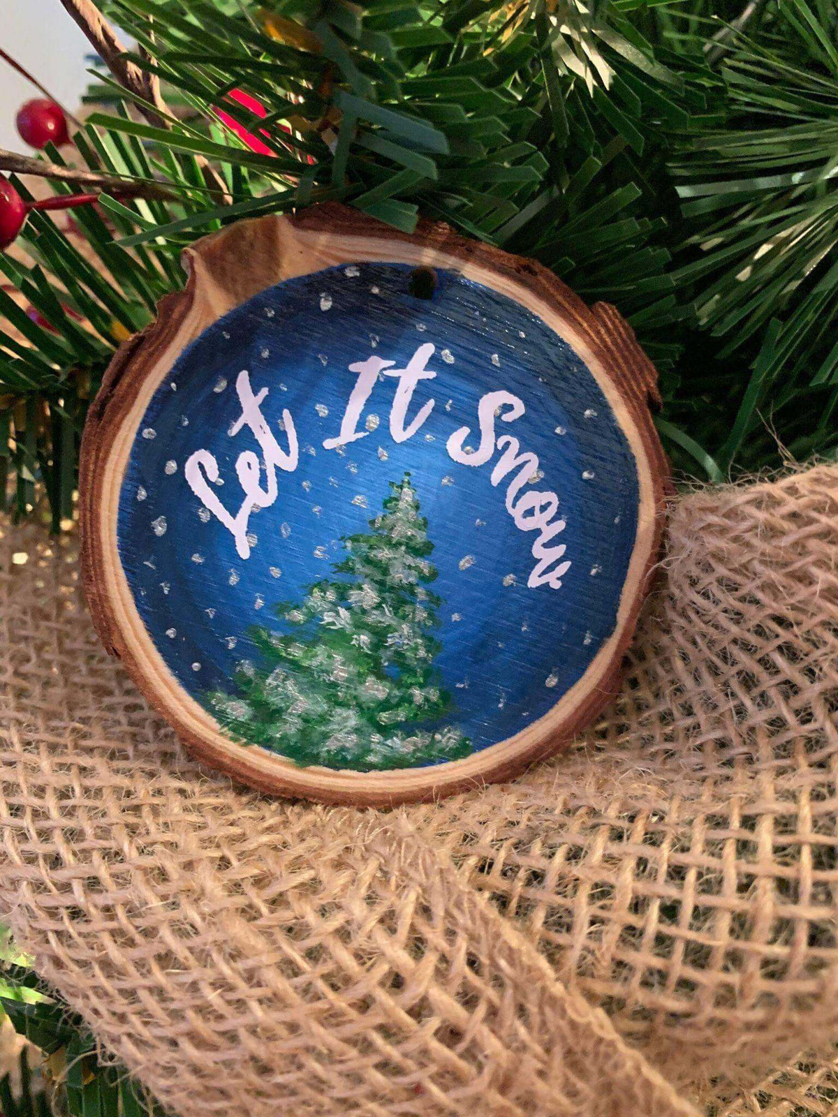 Hand-painted wood slice Christmas ornament featuring "Let it Snow" design by Winks Design Studio, LLC.