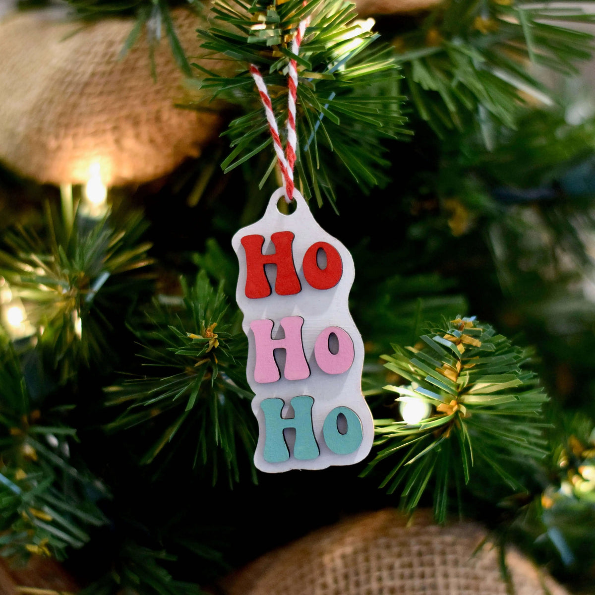 Wood engraved HoHoHo ornament by Winks Design Studio, LLC featuring festive holiday lettering and detailed craftsmanship.