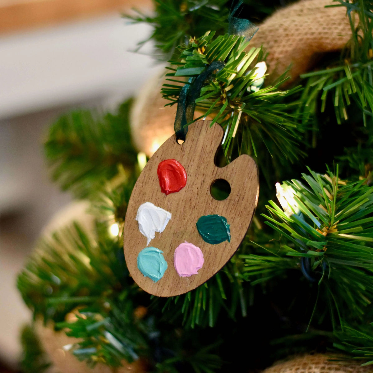 Wooden paint palette ornament by Winks Design Studio, LLC, featuring detailed craftsmanship and artistic design.
