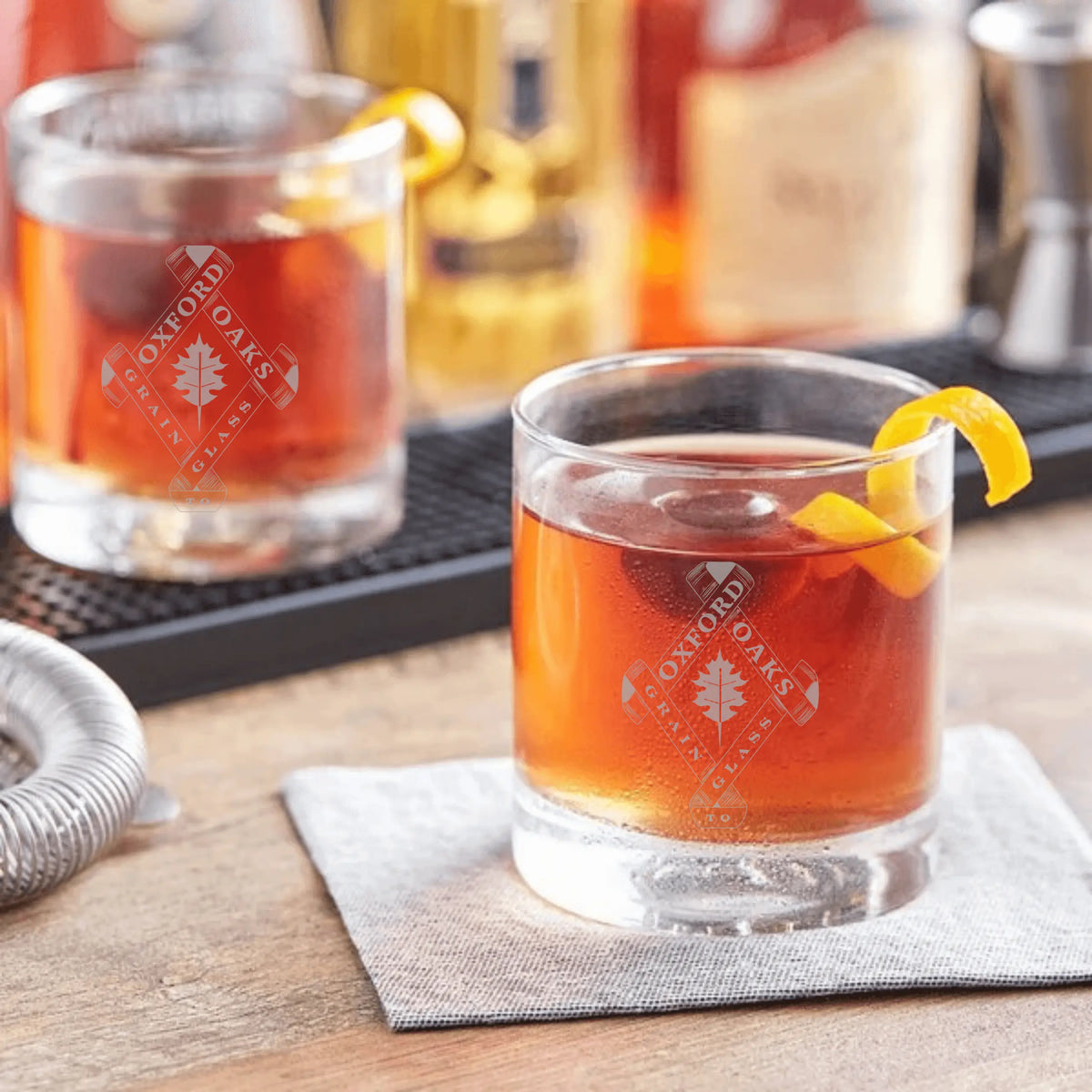 Winks Design Studio LLC Oxford Oaks Distillery Rocks Glass, clear single rocks glass with elegant design, ideal for whiskey or cocktails.