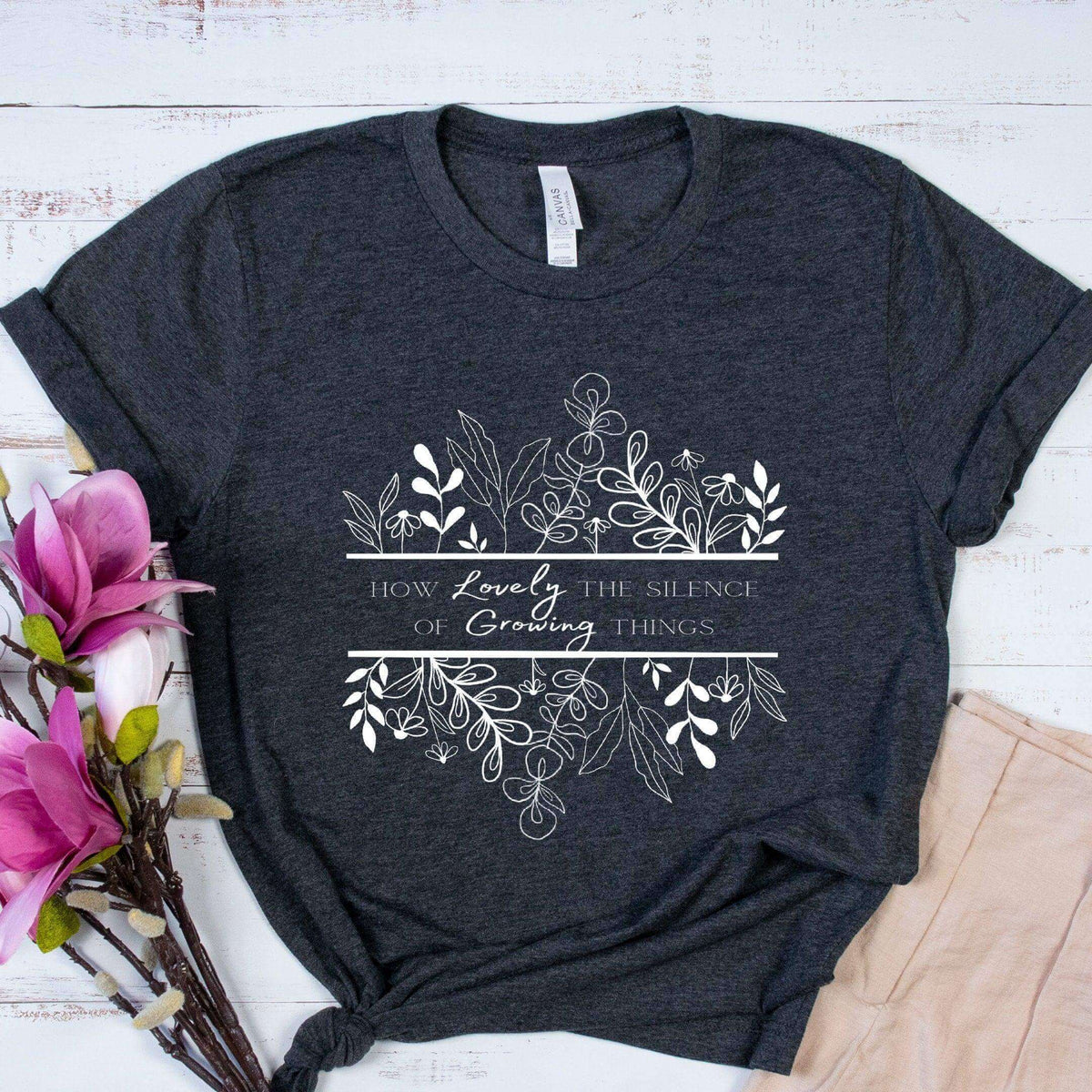 Black How Lovely the Silence of Growing Things T-shirt by Winks Design Studio, LLC, featuring a simple, stylish design.