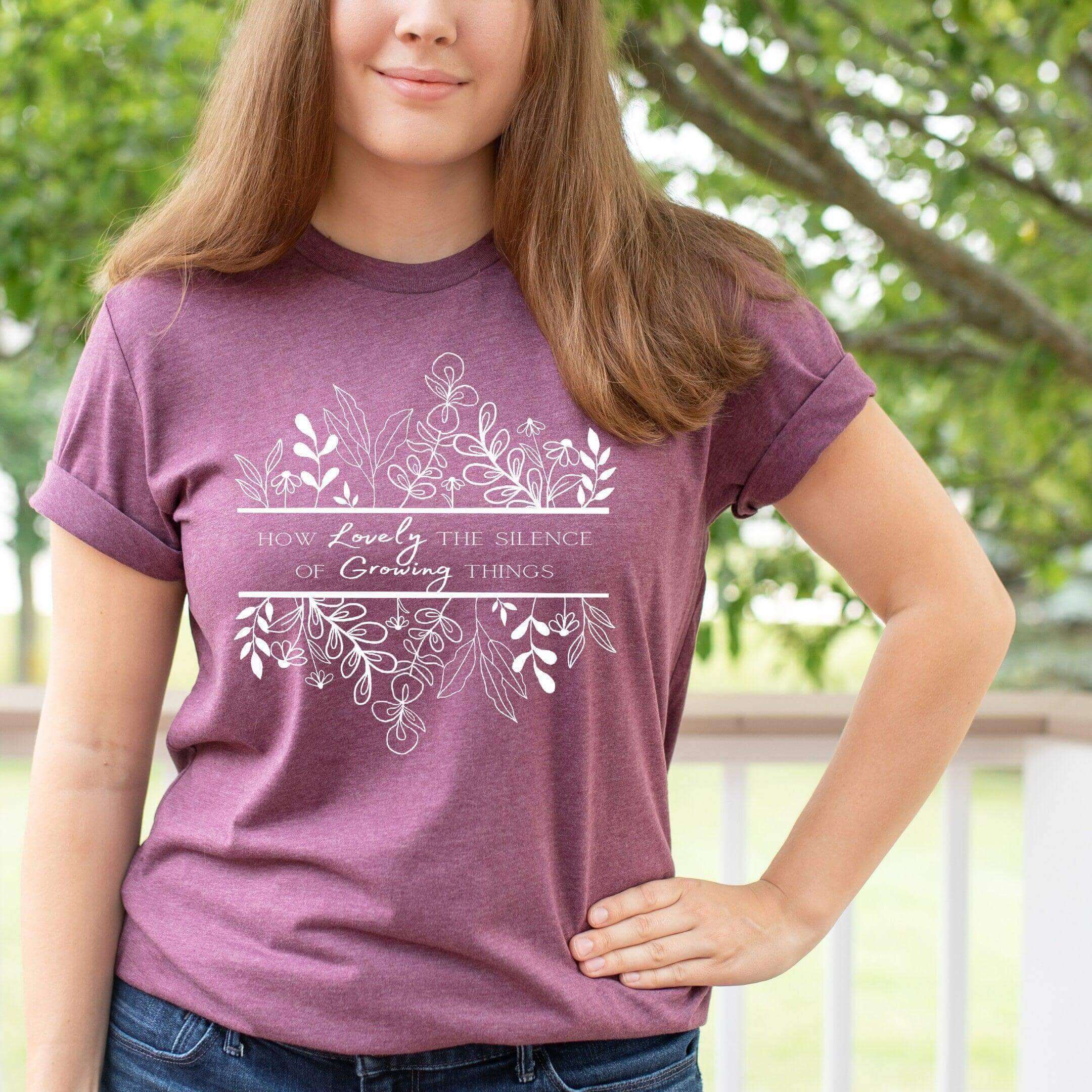 Black T-shirt by Winks Design Studio LLC featuring the phrase "How Lovely the Silence of Growing Things" in a stylish design.