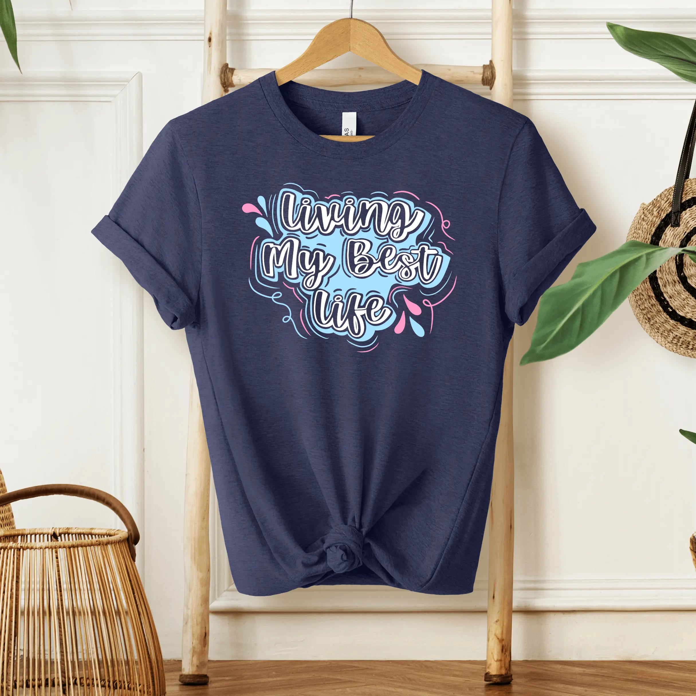 Black graphic T-shirt by Winks Design Studio featuring "Living My Best Life" slogan, casual style for everyday wear.