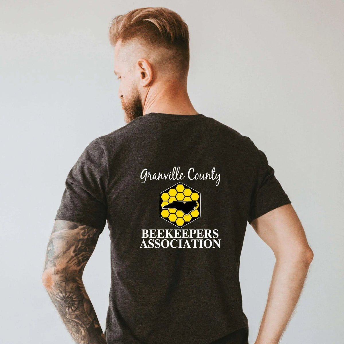 White GCBA Full Back Image T-Shirt by Winks Design Studio LLC, casual shirt with graphic design on the back.