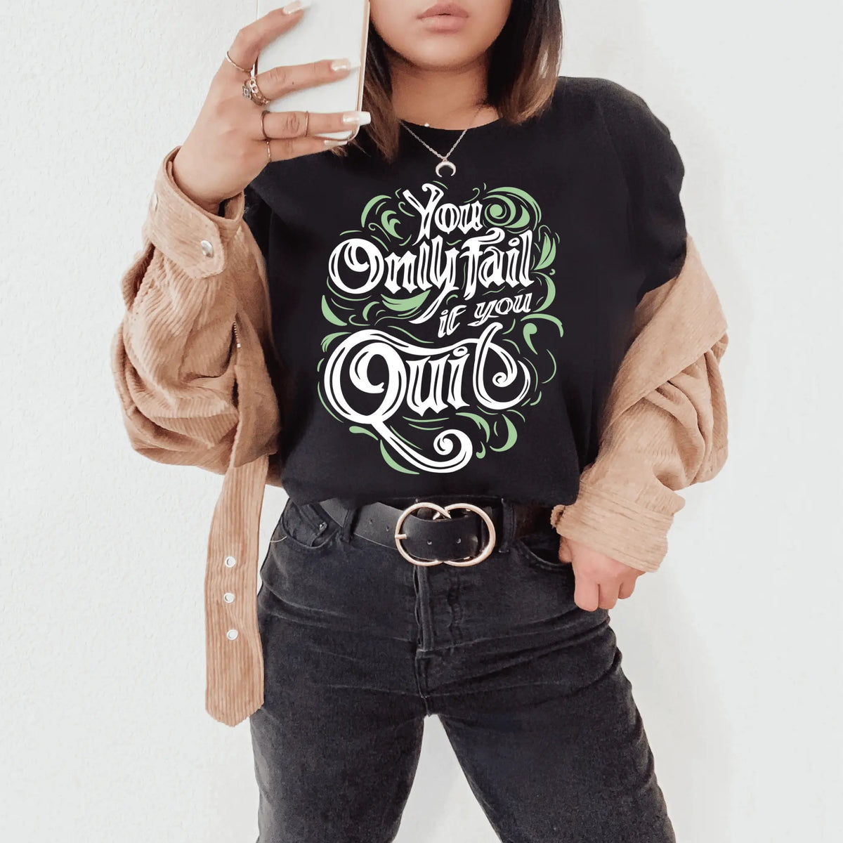 Black short sleeve "You Only Fail If You Quit" T-shirt by Winks Design Studio, LLC, showing front view with bold text design.