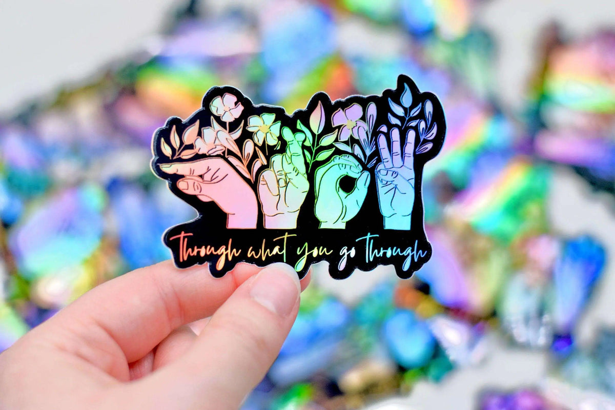 ASL sticker from Winks Design Studio with the phrase "Grow Through What You Go Through" in bold lettering.