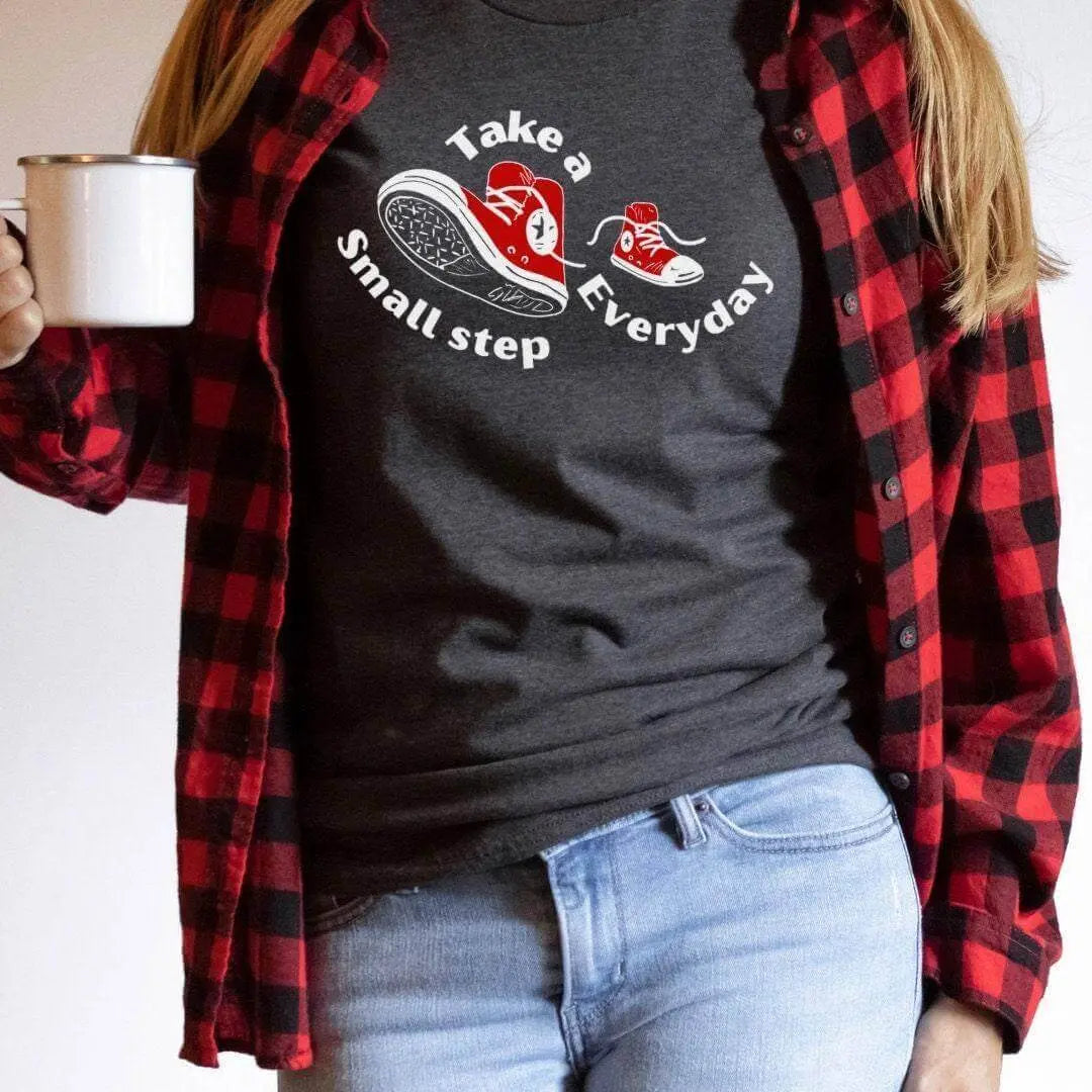 Black Take a Small Step Everyday T-Shirt by Winks Design Studio, LLC, featuring a comfortable fit and motivational text.