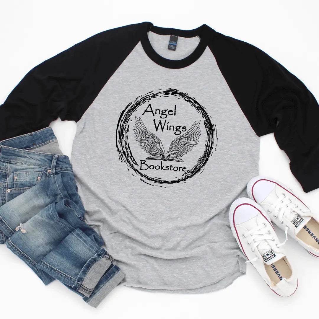 Black and white raglan baseball T-shirt by Winks Design Studio featuring angel wings and bookstore-themed graphic.