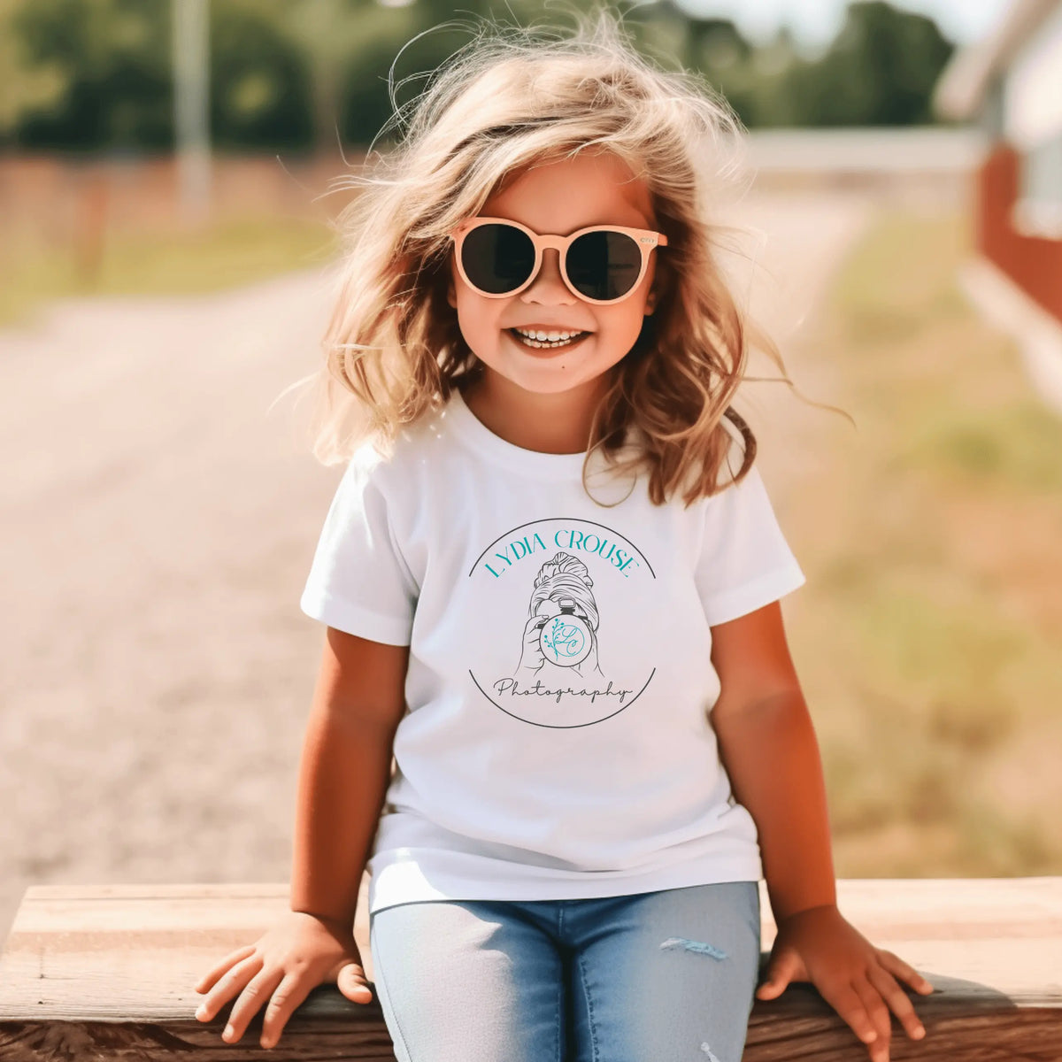 Youth Lydia Crouse Photography T-shirt by Winks Design Studio, LLC, featuring a circular camera graphic on a casual T-shirt.