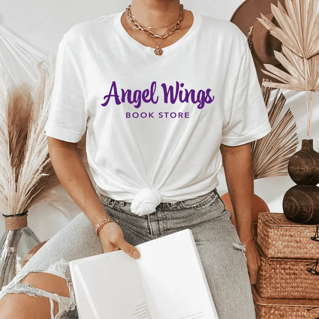 Heather purple horizontal T-shirt with angel wings design by Winks Design Studio, LLC, featuring bookstore-themed artwork.