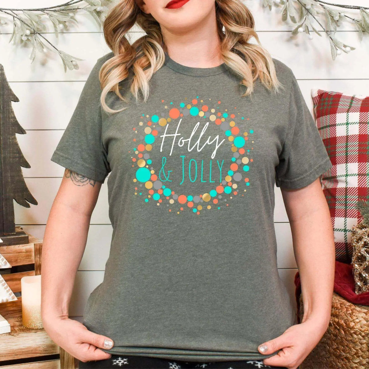 Military green Holly Jolly Christmas T-shirt by Winks Design Studio, LLC with festive holiday design on the front.