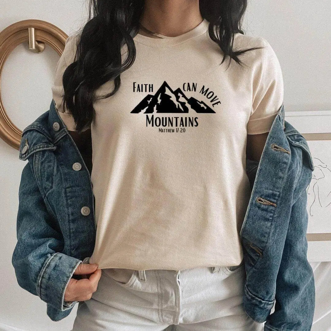 Peach Christian T-shirt by Winks Design Studio featuring the quote "Faith Can Move Mountains" with mountain graphic.