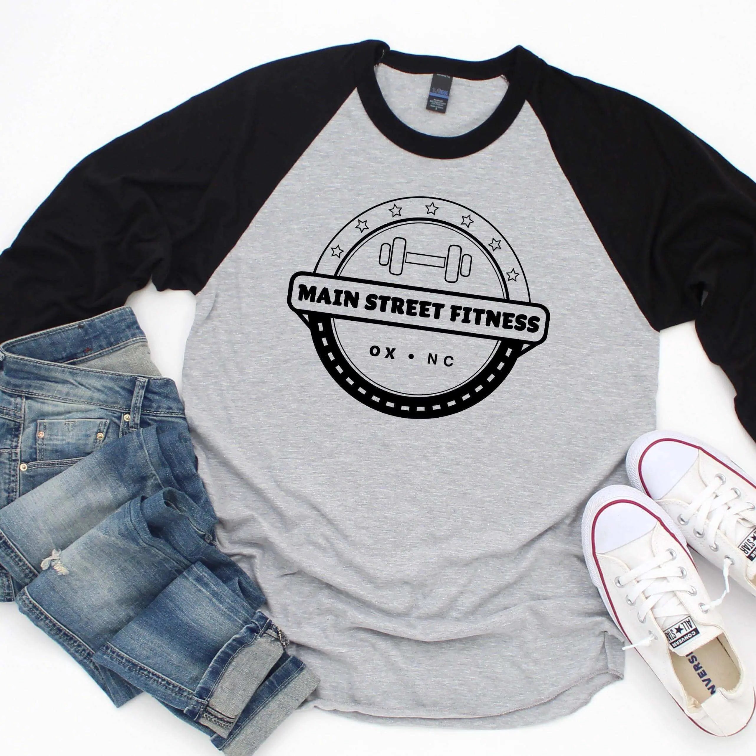 Red and white raglan baseball T-shirt by Winks Design Studio, LLC, featuring Main Street Fitness branding and casual athletic style.