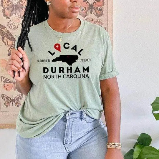 Sage green custom city and state short sleeve T-shirt by Winks Design Studio, LLC, featuring a personalized city and state design.