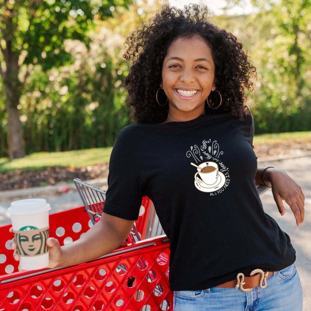 Winks Design Studio LLC All You Need Is Love and More Coffee T-shirt featuring a cozy, graphic print on a casual black T-shirt.