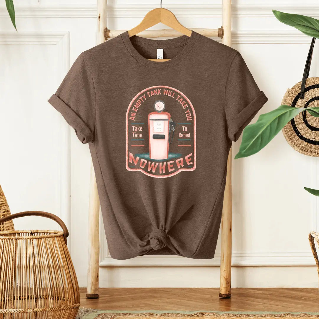 Winks Design Studio LLC T-shirt featuring the slogan "An Empty Tank Will Take You Nowhere" in black text on a casual tee