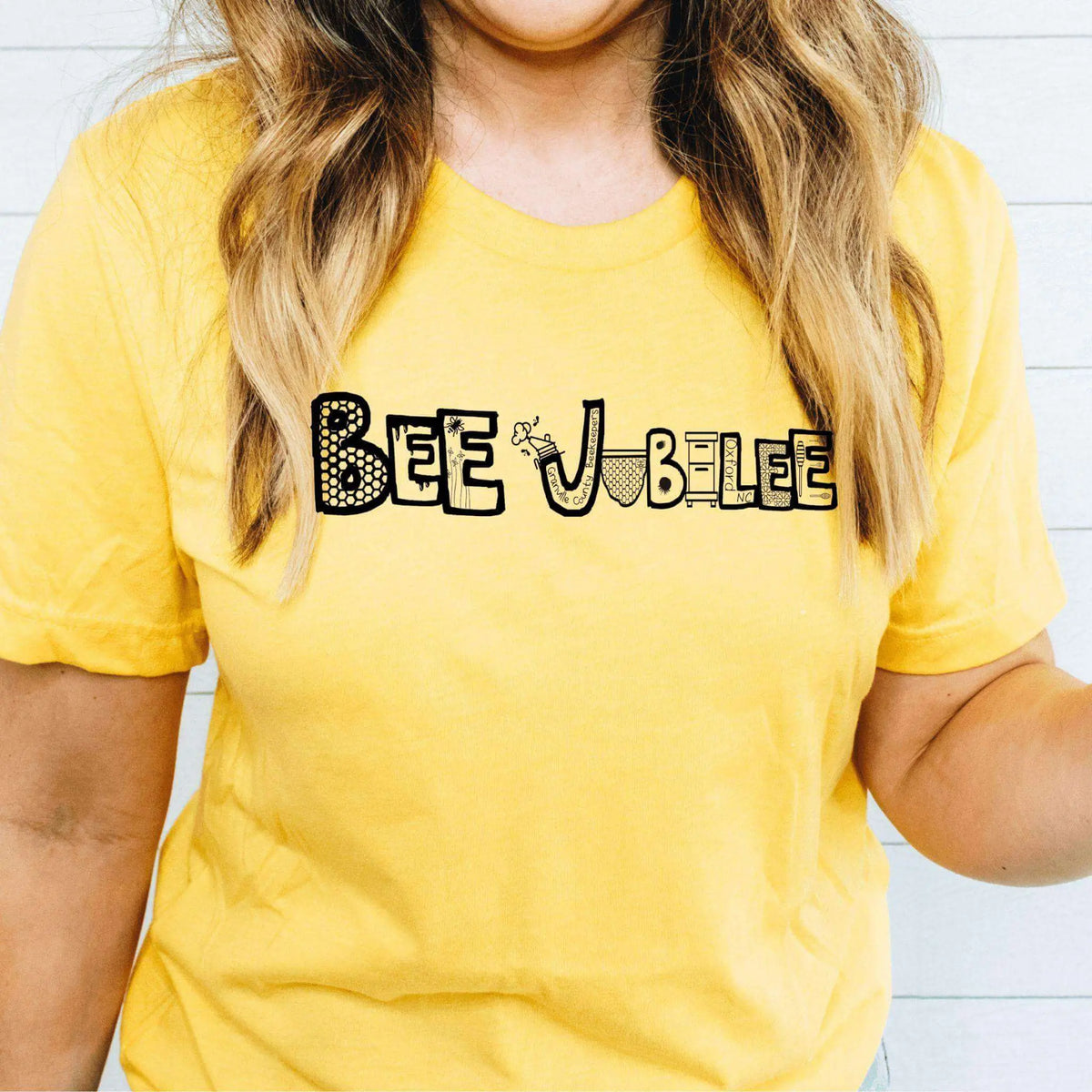 Winks Design Studio Bee Jubilee short sleeve T-shirt featuring a colorful bee graphic on a casual cotton shirt.