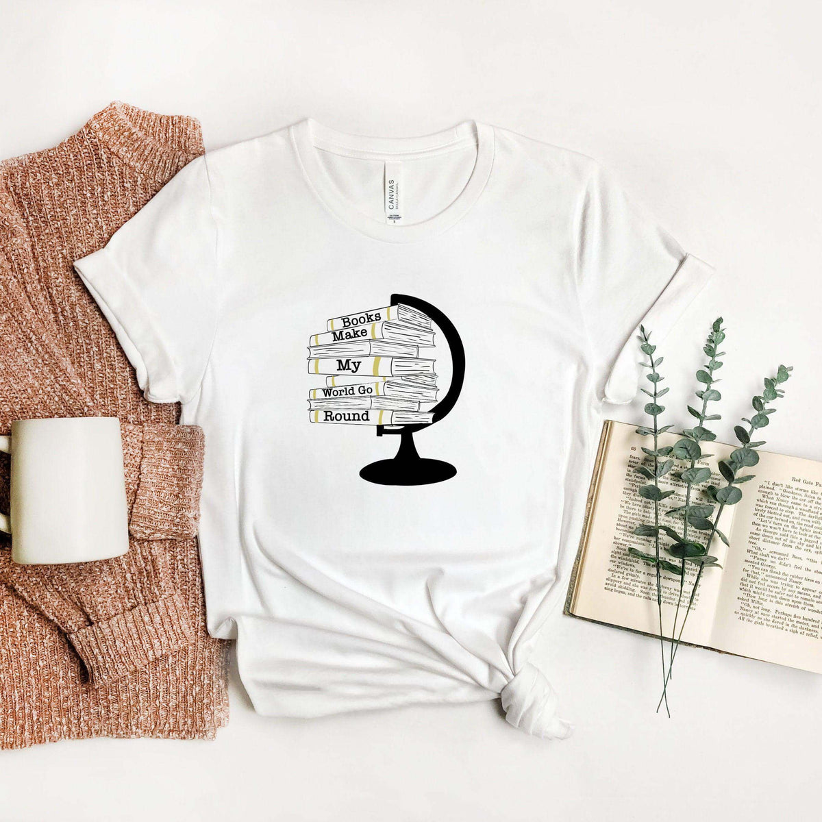 Winks Design Studio LLC Books Make My World Go Round T-shirt featuring a colorful book-themed graphic on a casual tee.
