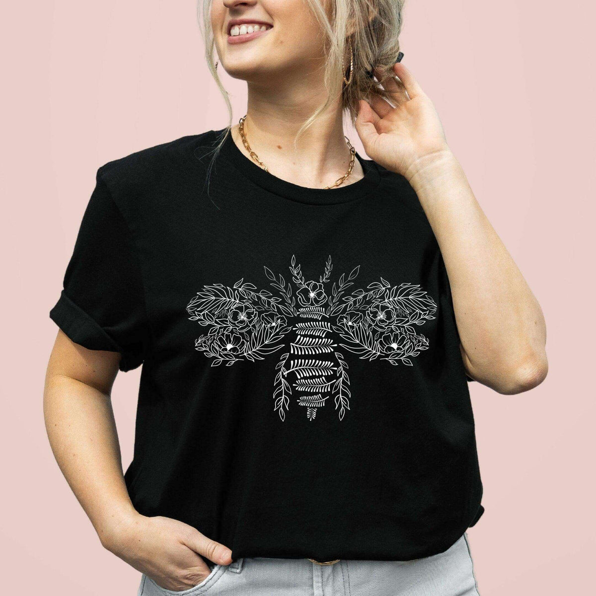 Flower bee graphic T-shirt from Winks Design Studio, LLC featuring a colorful floral and bee design on a casual shirt.