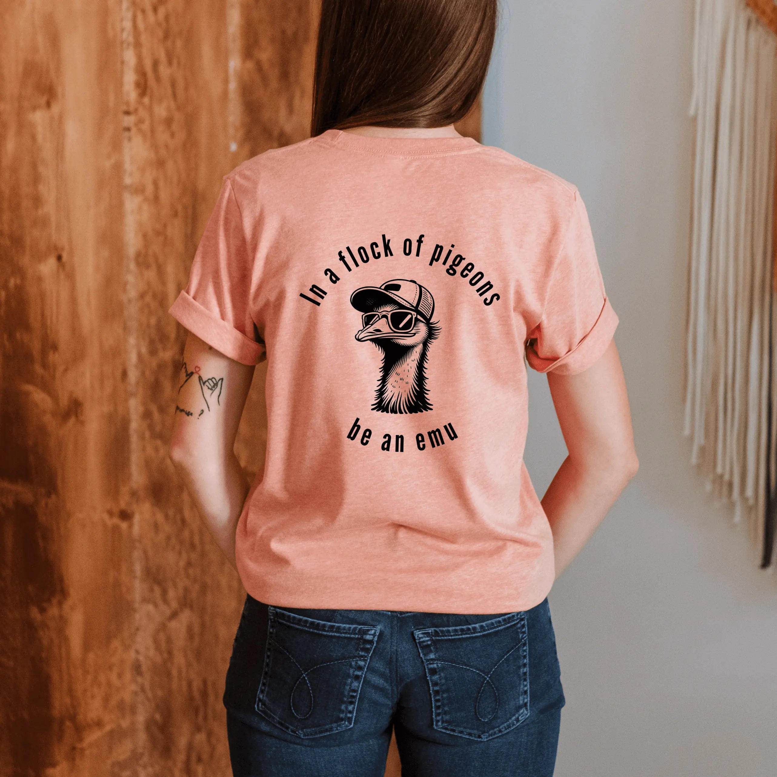 Winks Design Studio LLC R &amp; R short sleeve T-shirt featuring a flock of pigeons with a humorous "Be an Emu" slogan.