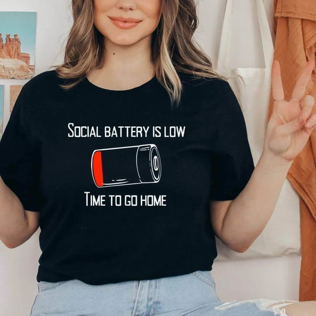 Winks Design Studio LLC Social Battery Is Low T-shirt featuring a humorous graphic and casual fit.