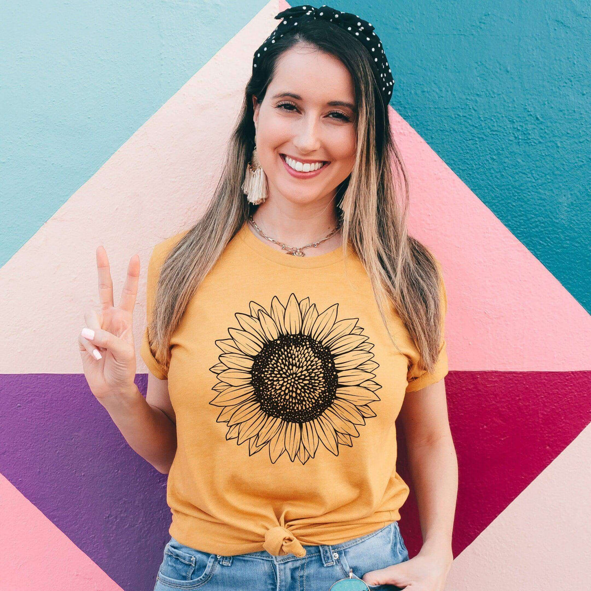 Small sunflower T-shirt by Winks Design Studio, LLC featuring a vibrant sunflower graphic on soft fabric.