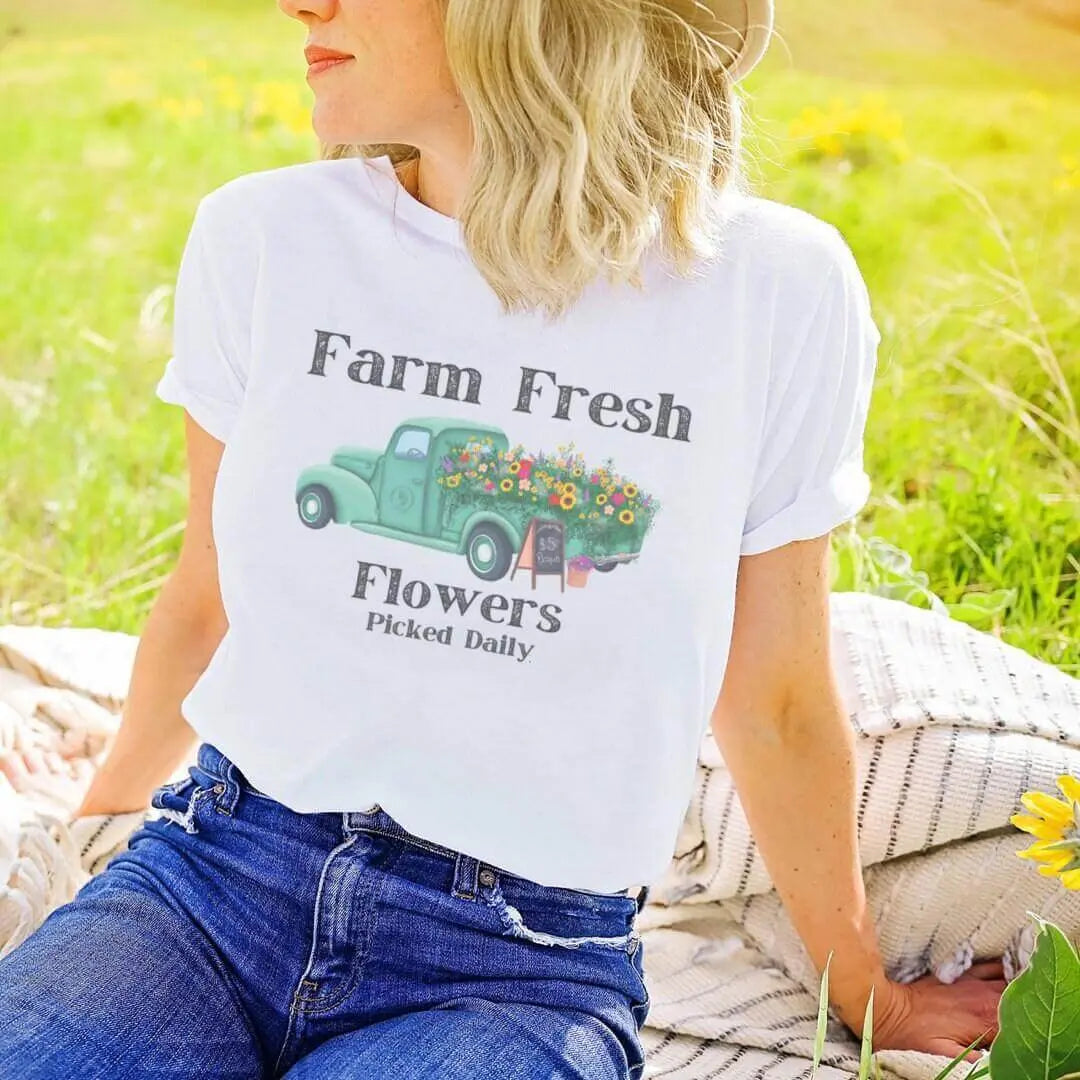 Vintage flower truck T-shirt by Winks Design Studio featuring a colorful floral truck graphic on soft fabric.