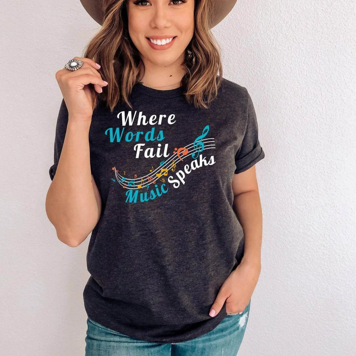 Winks Design Studio LLC Where Words Fail Music Speaks T-shirt shown in black with white text on the front.