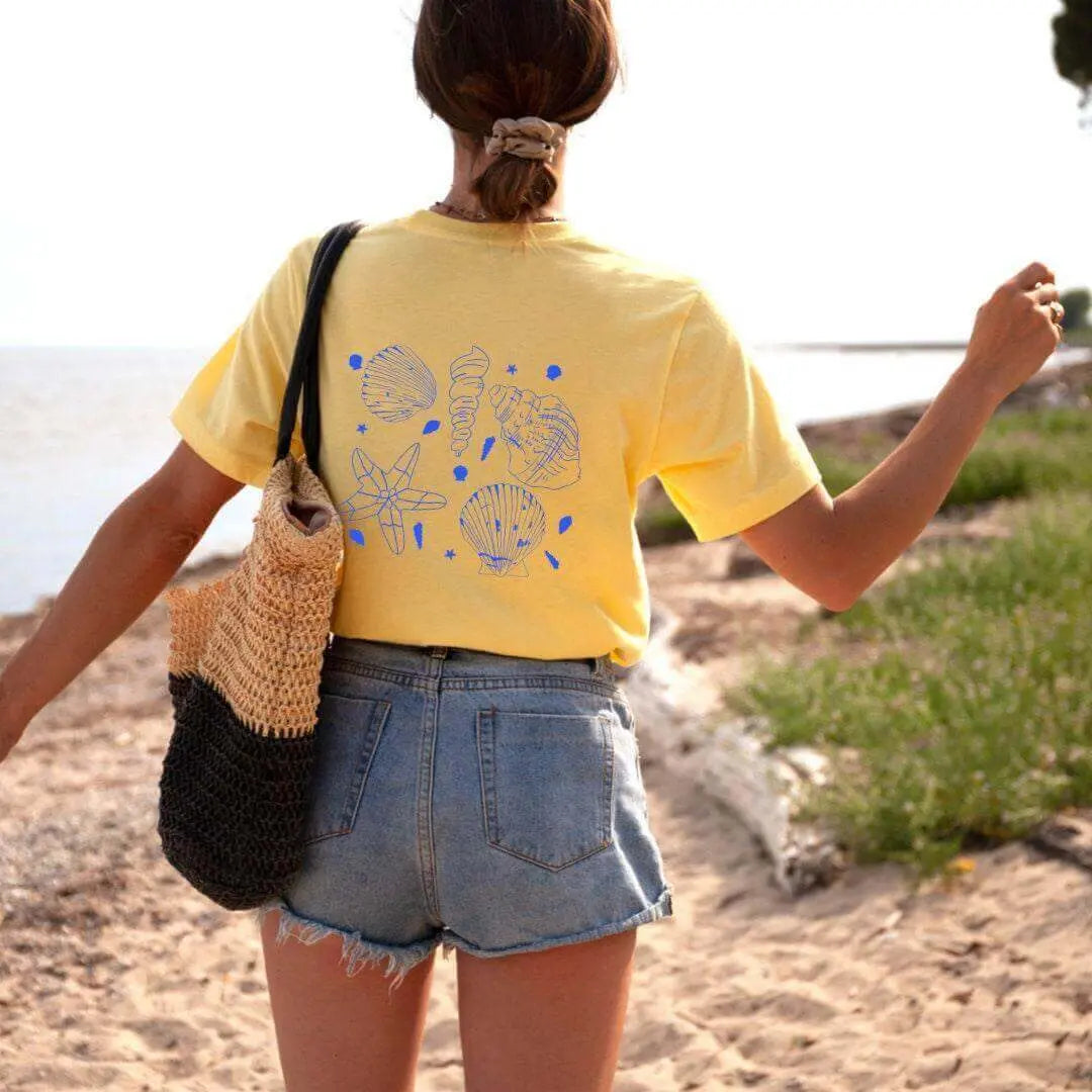White Seashell T-Shirt from Winks Design Studio featuring a nautical beachwear design, ideal for casual seaside wear.