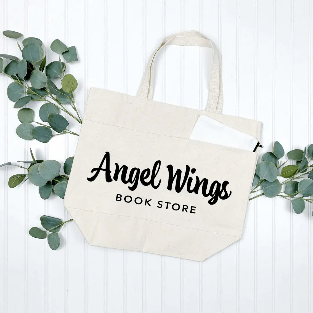 Natural canvas tote bag with angel wing design, featuring multiple pockets, from Winks Design Studio LLC.