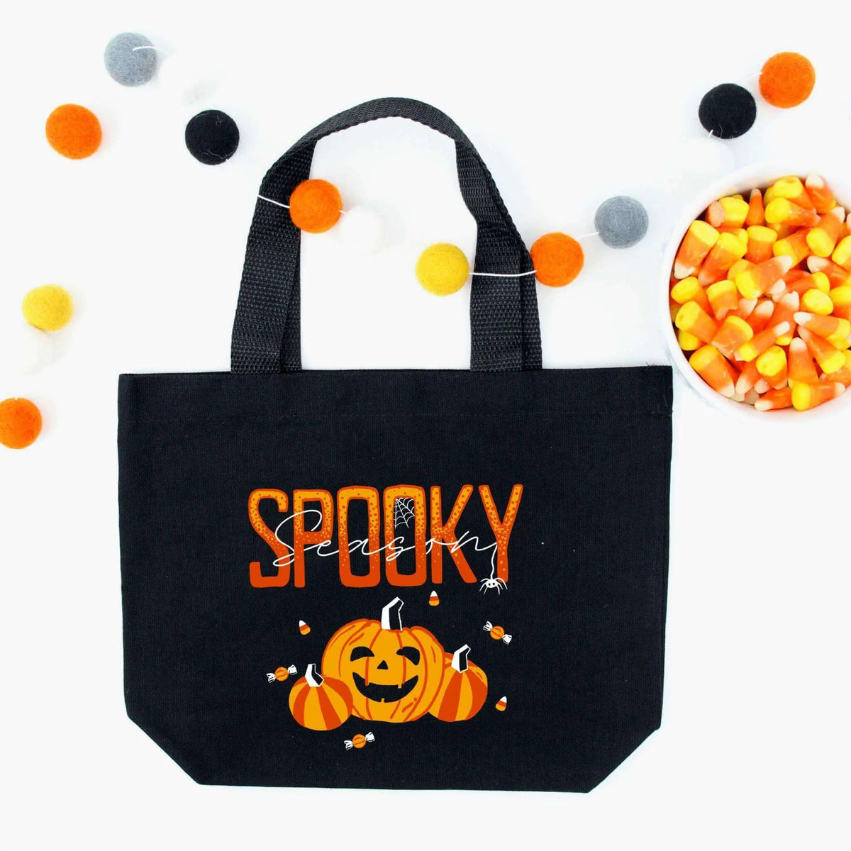 Spooky Season Canvas Tote Bag by Winks Design Studio, LLC featuring Halloween-themed artwork and sturdy fabric for carrying.