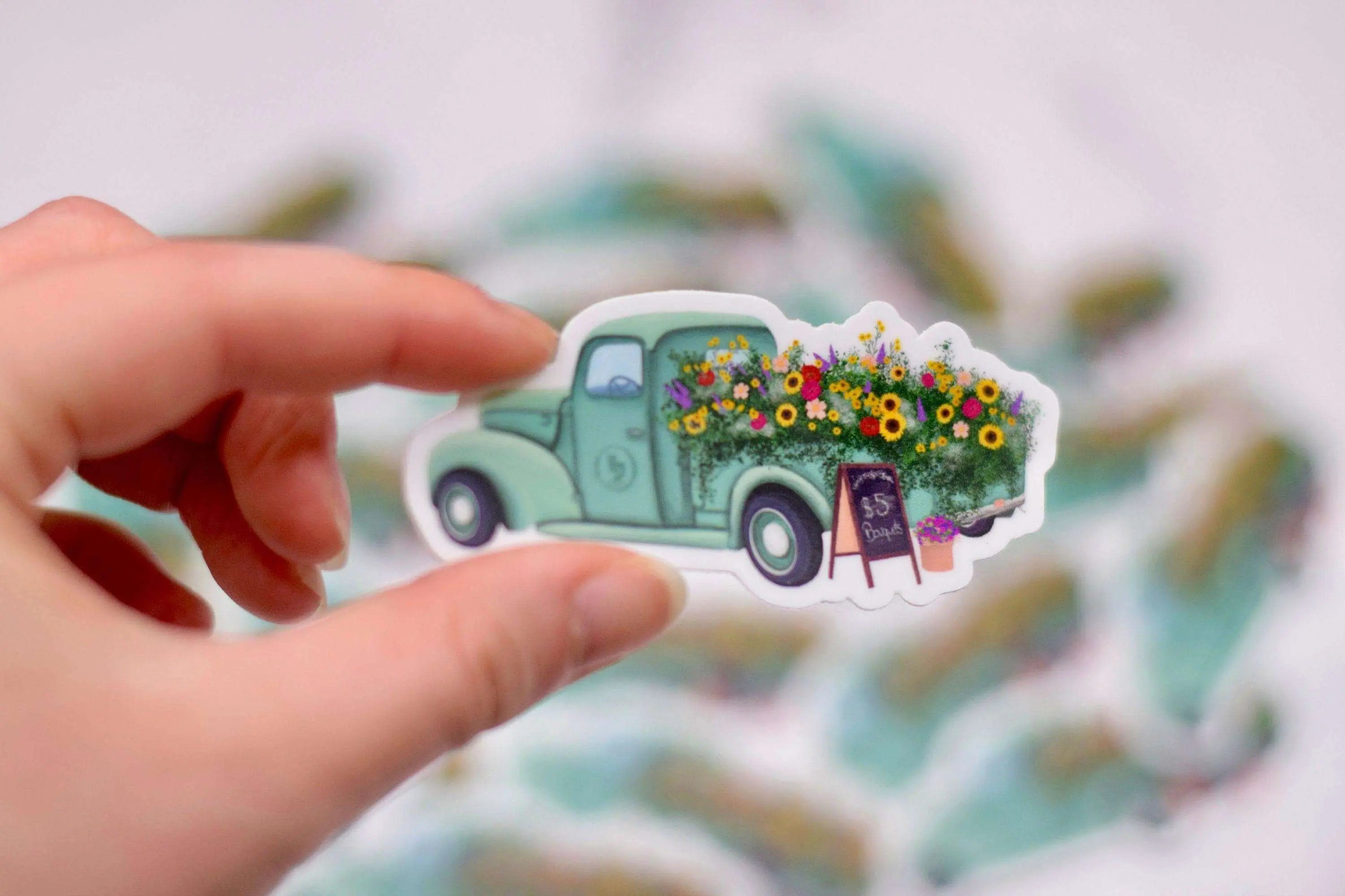 Antique flower truck vinyl sticker from Winks Design Studio, LLC, measuring 1.25x3 inches, featuring vintage floral truck design.
