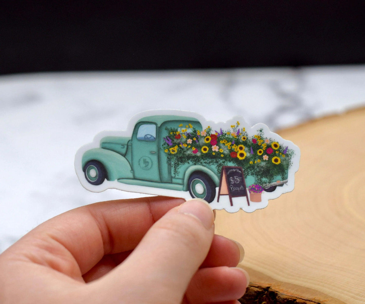 Antique flower truck vinyl sticker by Winks Design Studio, LLC, measuring 1.25x3 inches, featuring a vintage floral truck design.