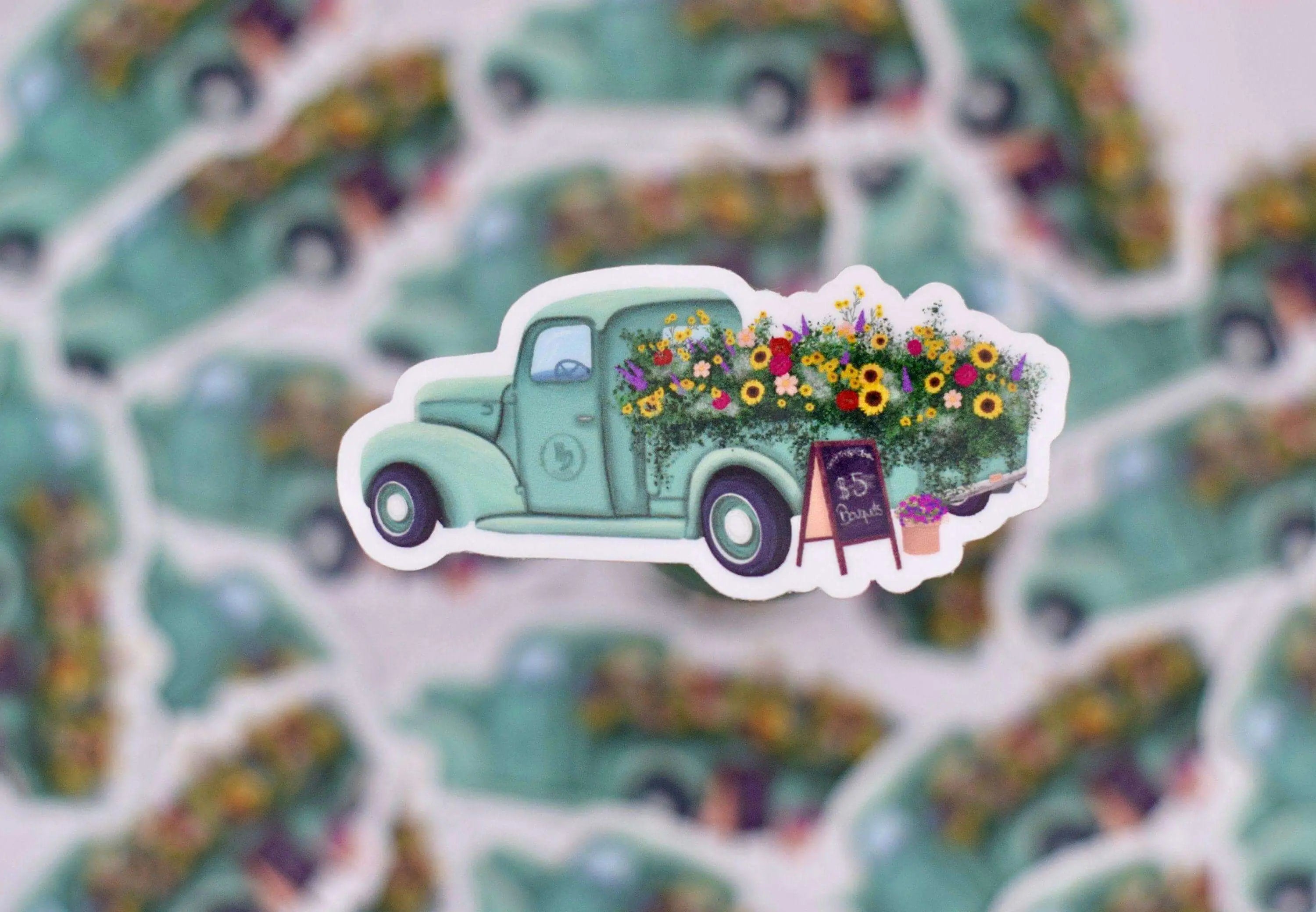 Antique flower truck vinyl sticker by Winks Design Studio, LLC measuring 1.25x3 inches, featuring colorful floral and vintage truck design.