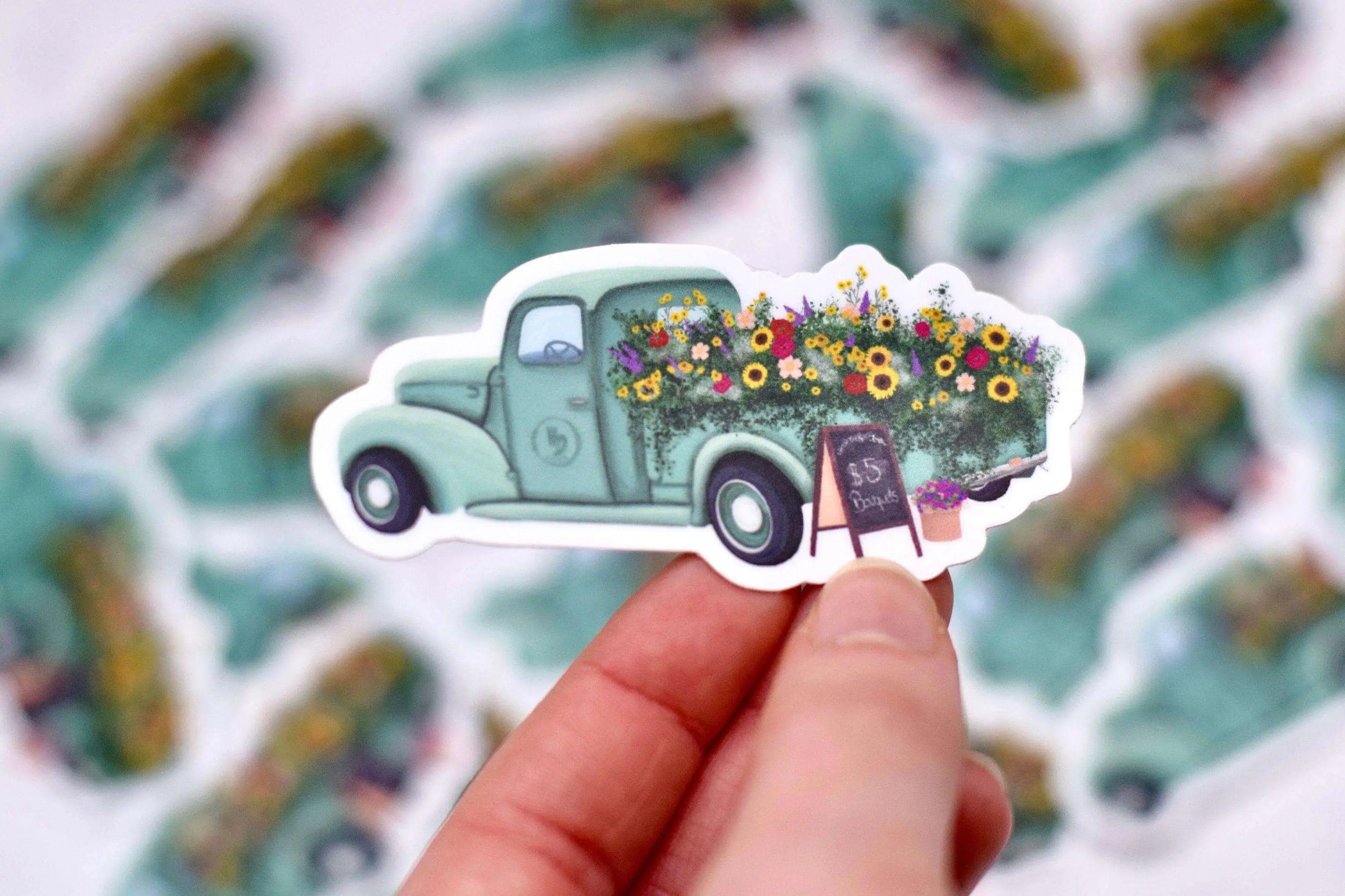 Antique flower truck vinyl sticker from Winks Design Studio, LLC, measuring 1.25x3 inches, featuring colorful floral and truck design.