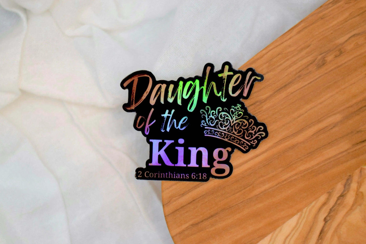Vinyl sticker featuring the "Daughter of The King" design by Winks Design Studio, LLC, with elegant lettering and decorative elements.