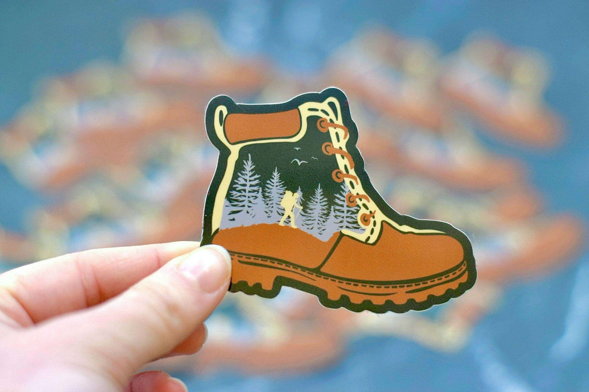 Vinyl hiking boot sticker by Winks Design Studio, LLC, featuring detailed illustration on a durable adhesive sticker.
