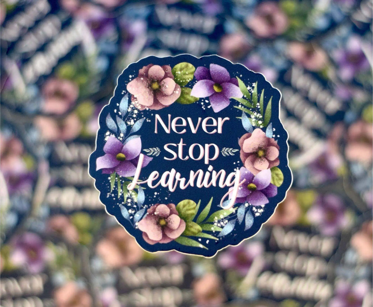 Vinyl sticker by Winks Design Studio featuring the phrase "Never Stop Learning" in black text on a 2x2 inch surface.