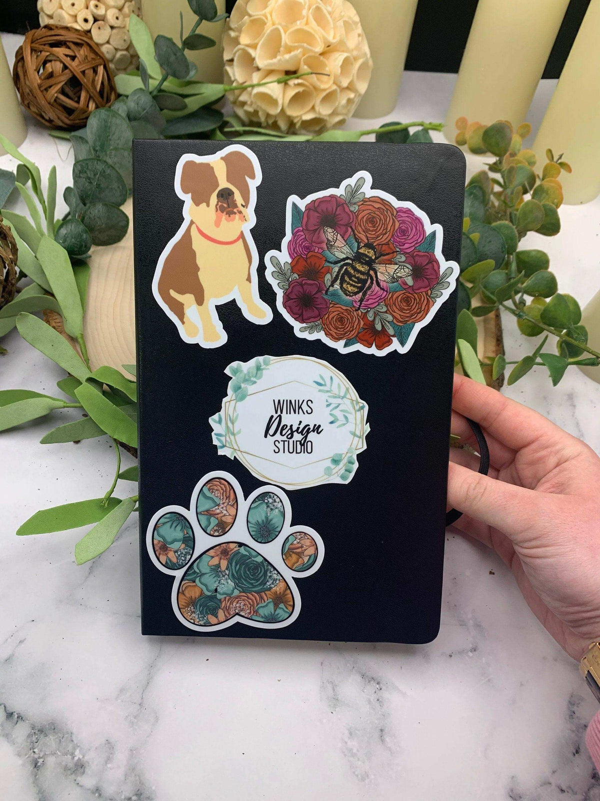 Vinyl paw print sticker by Winks Design Studio, LLC, 3x3 inches, featuring a realistic paw print design on a transparent background.