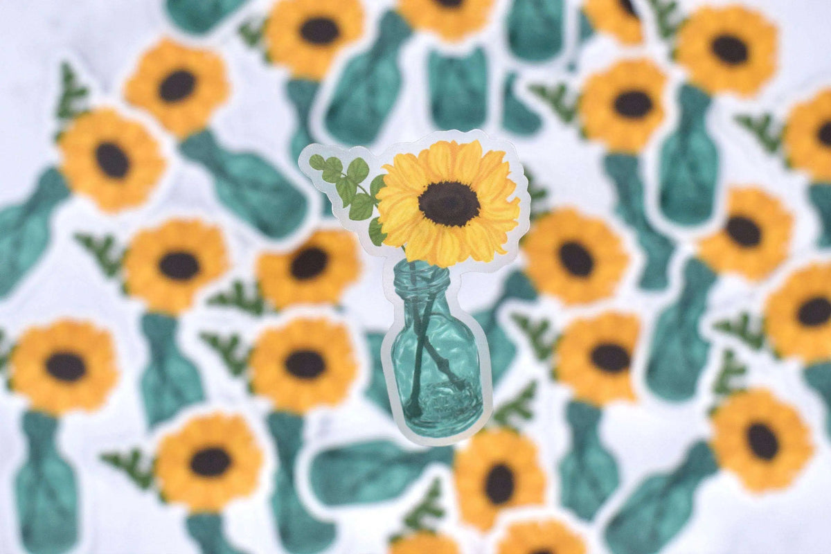 Transparent sunflower vinyl sticker from Winks Design Studio, LLC, featuring a detailed sunflower design on clear adhesive backing.