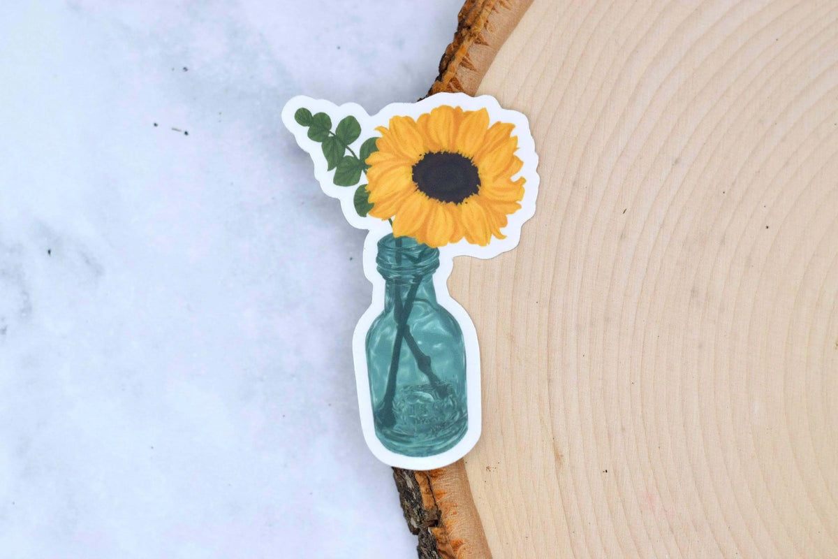 Clear vinyl sunflower sticker from Winks Design Studio, LLC featuring a bright sunflower design on transparent background.