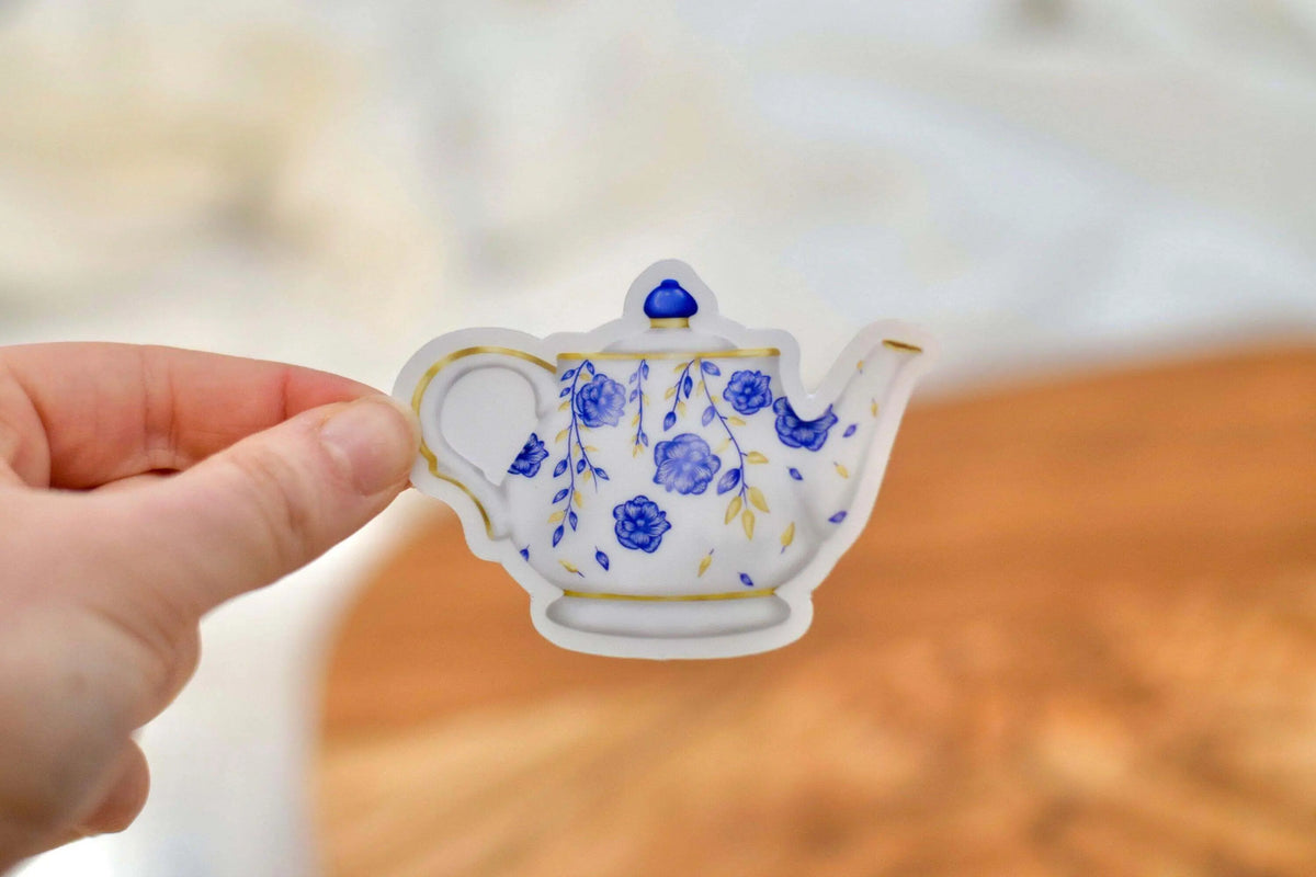 Vintage floral teapot vinyl sticker by Winks Design Studio, LLC, featuring colorful floral design on a classic teapot shape.