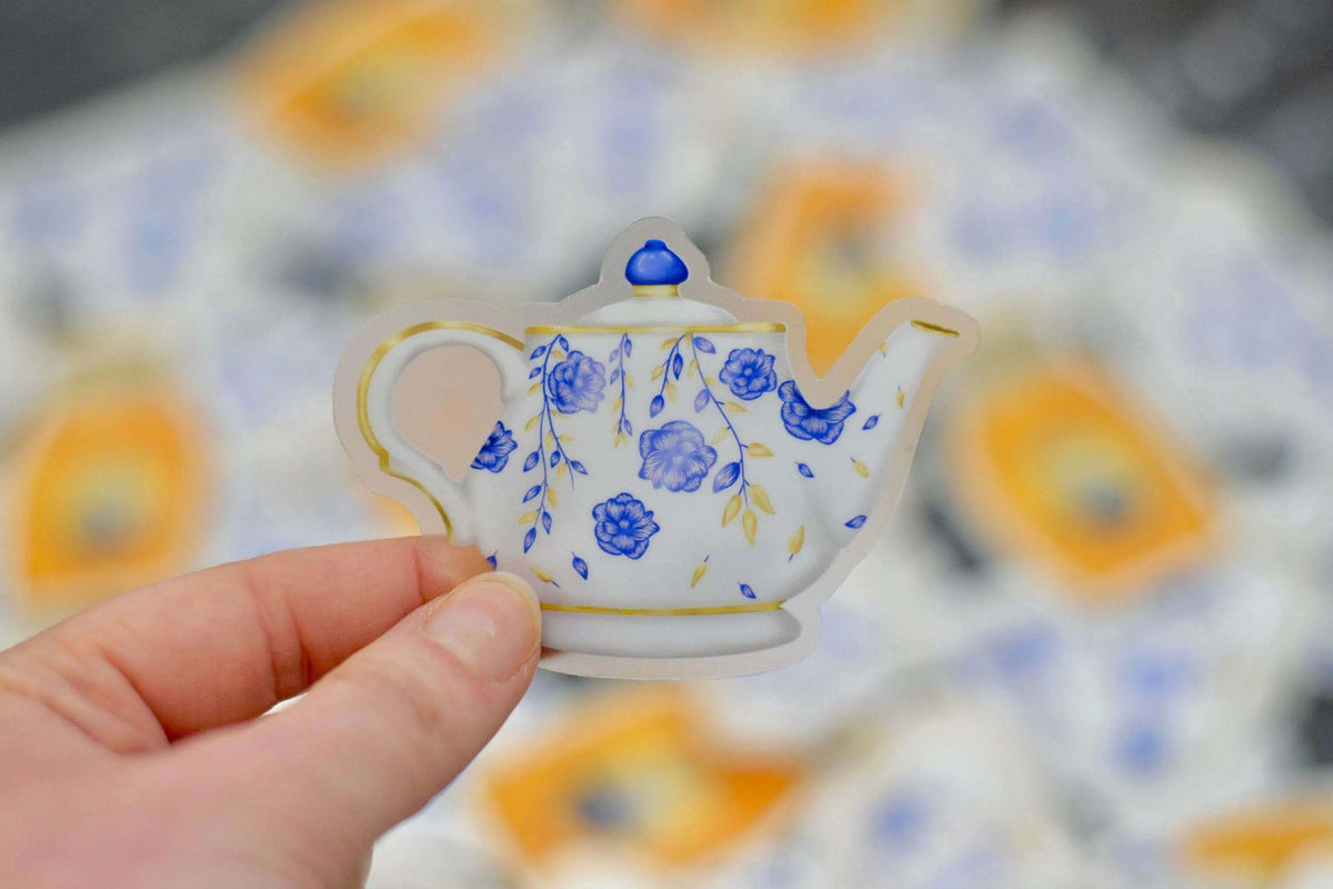 Vintage floral teapot vinyl sticker by Winks Design Studio, LLC featuring colorful floral patterns on a teapot design.