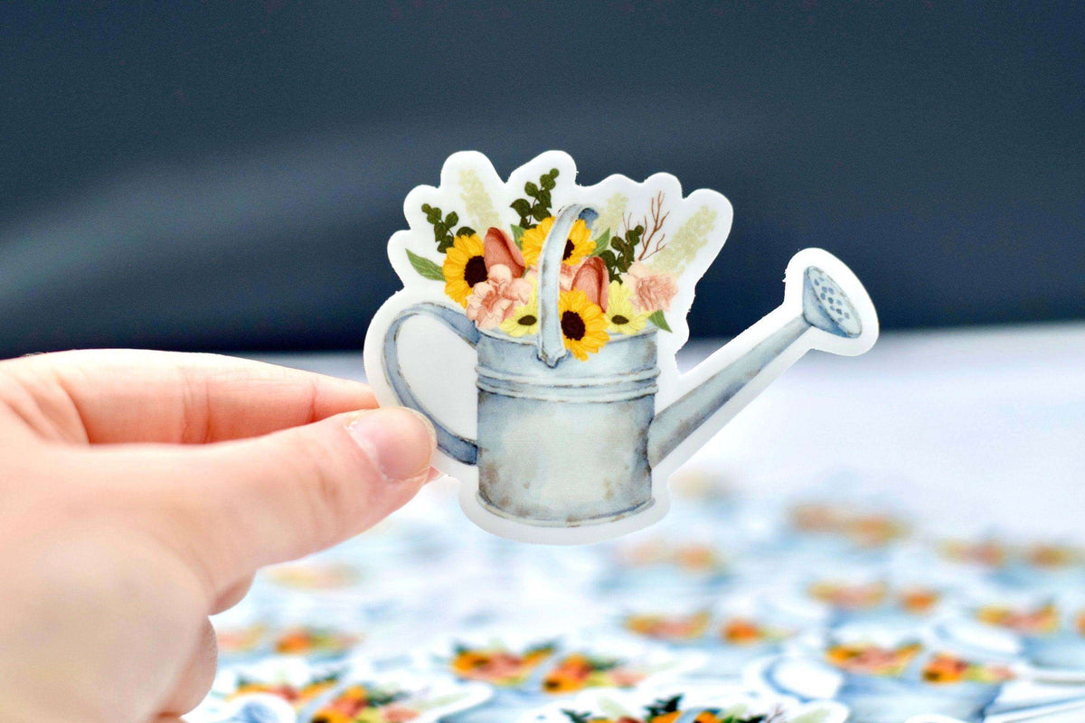 Vintage watering can vinyl sticker by Winks Design Studio, LLC, featuring a charming watering can design for decorative use.