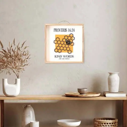 Wall art sign by Winks Design Studio with the quote "Kind words are like honey" in elegant lettering on a neutral background.